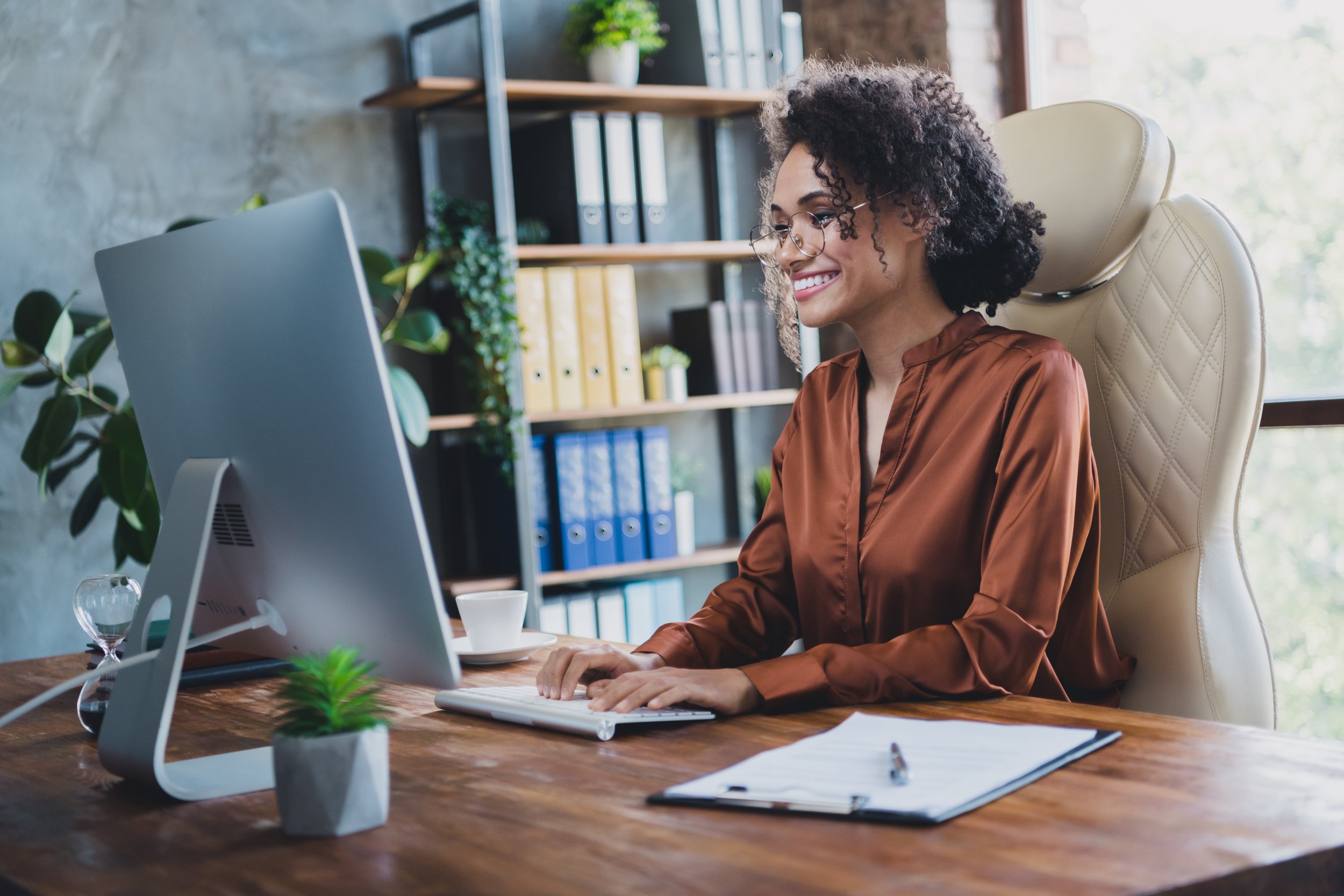 a person sitting at a desk using a computer