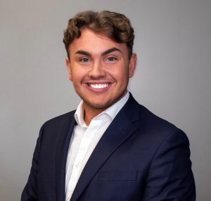 a person in a suit smiling