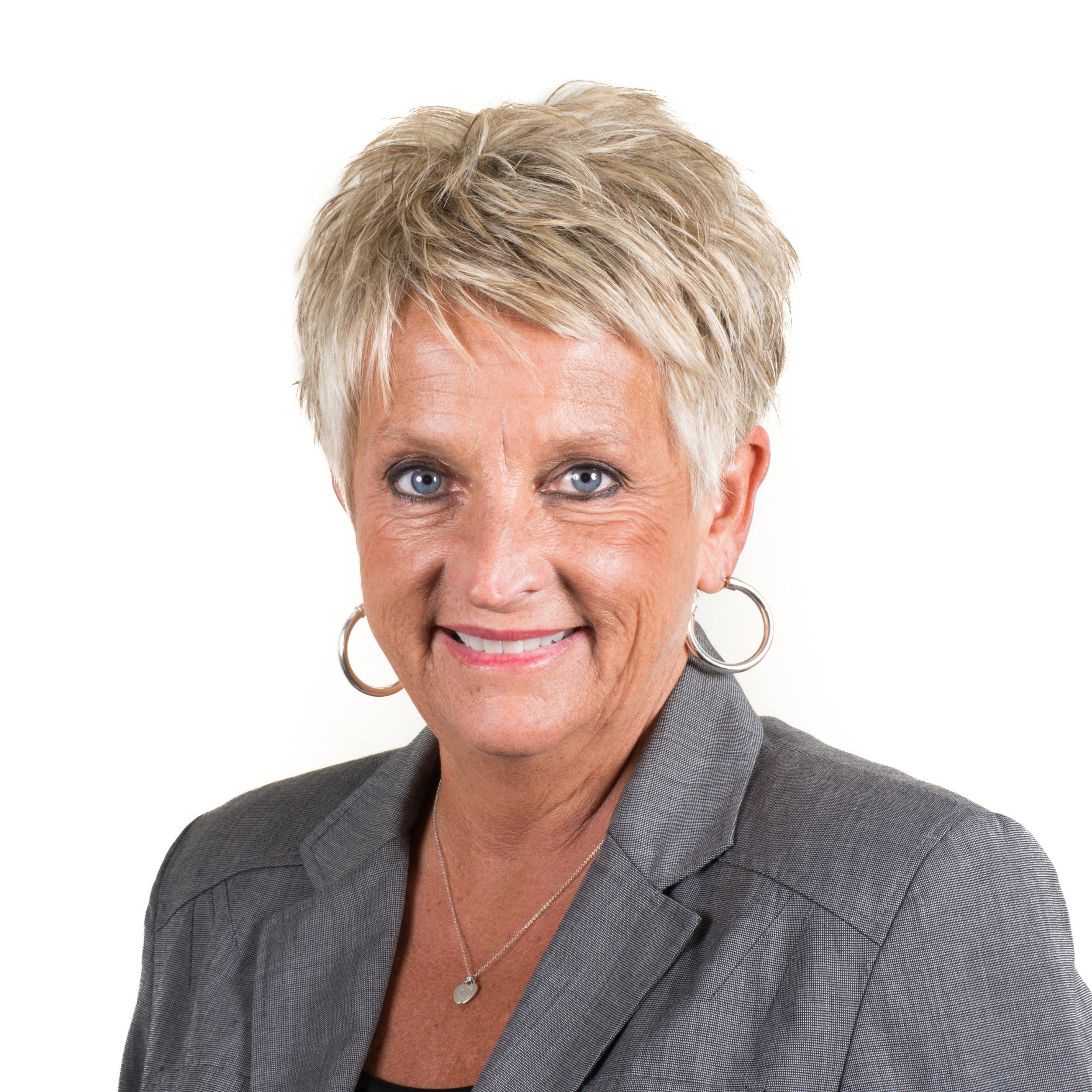 a person with short hair wearing a grey suit