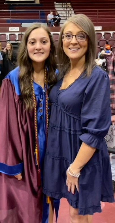 two women standing together smiling