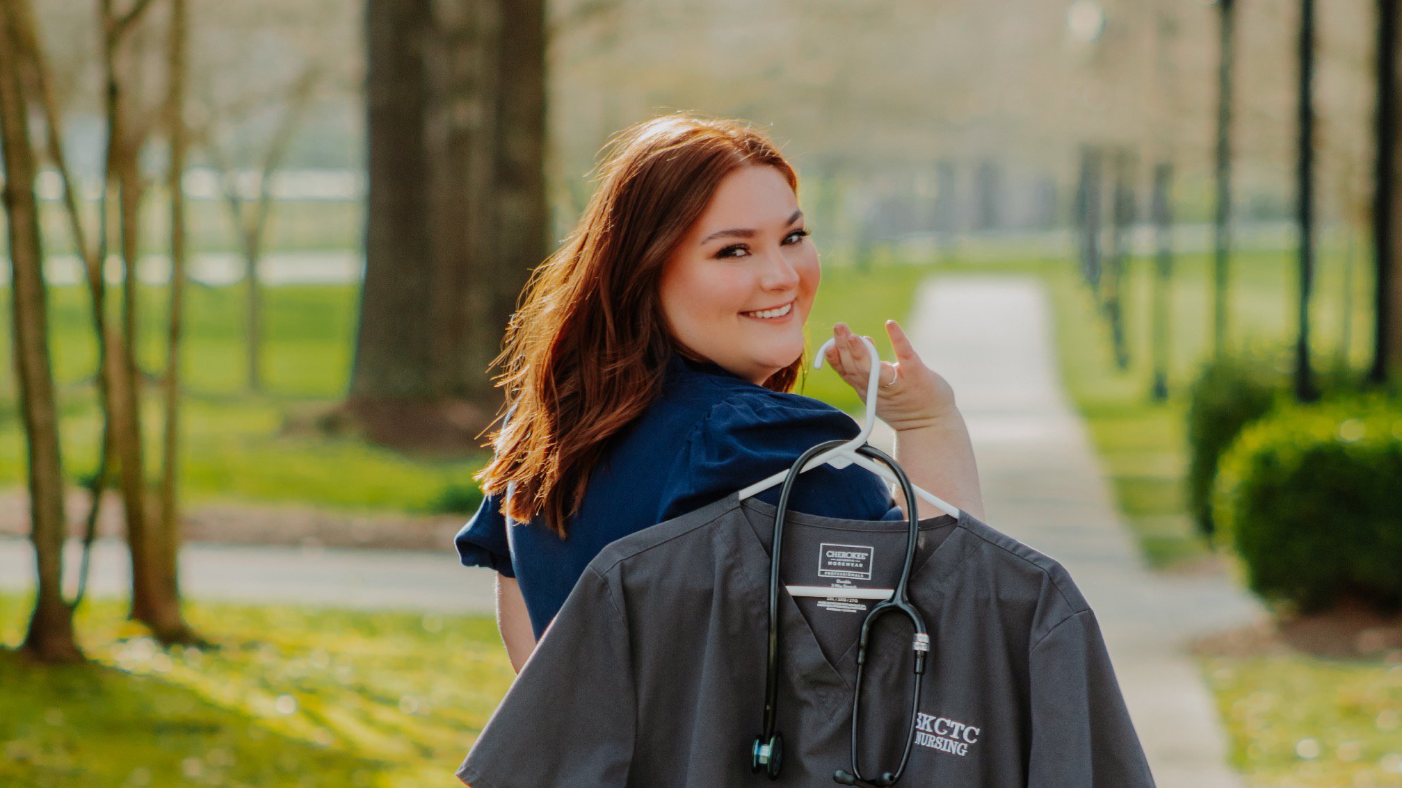 a person holding a coat on a swinger